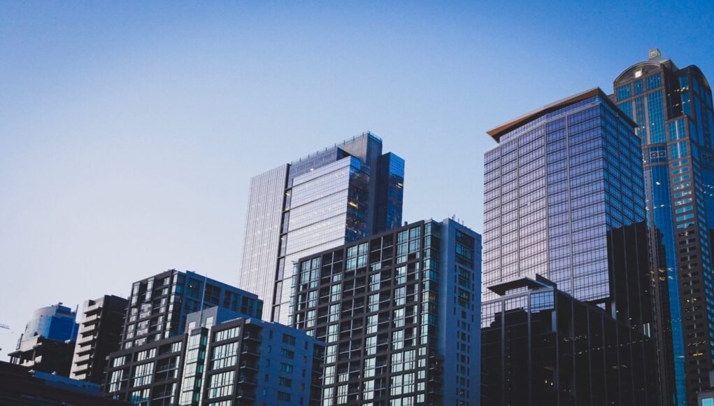 white and blue glass walled high rise building